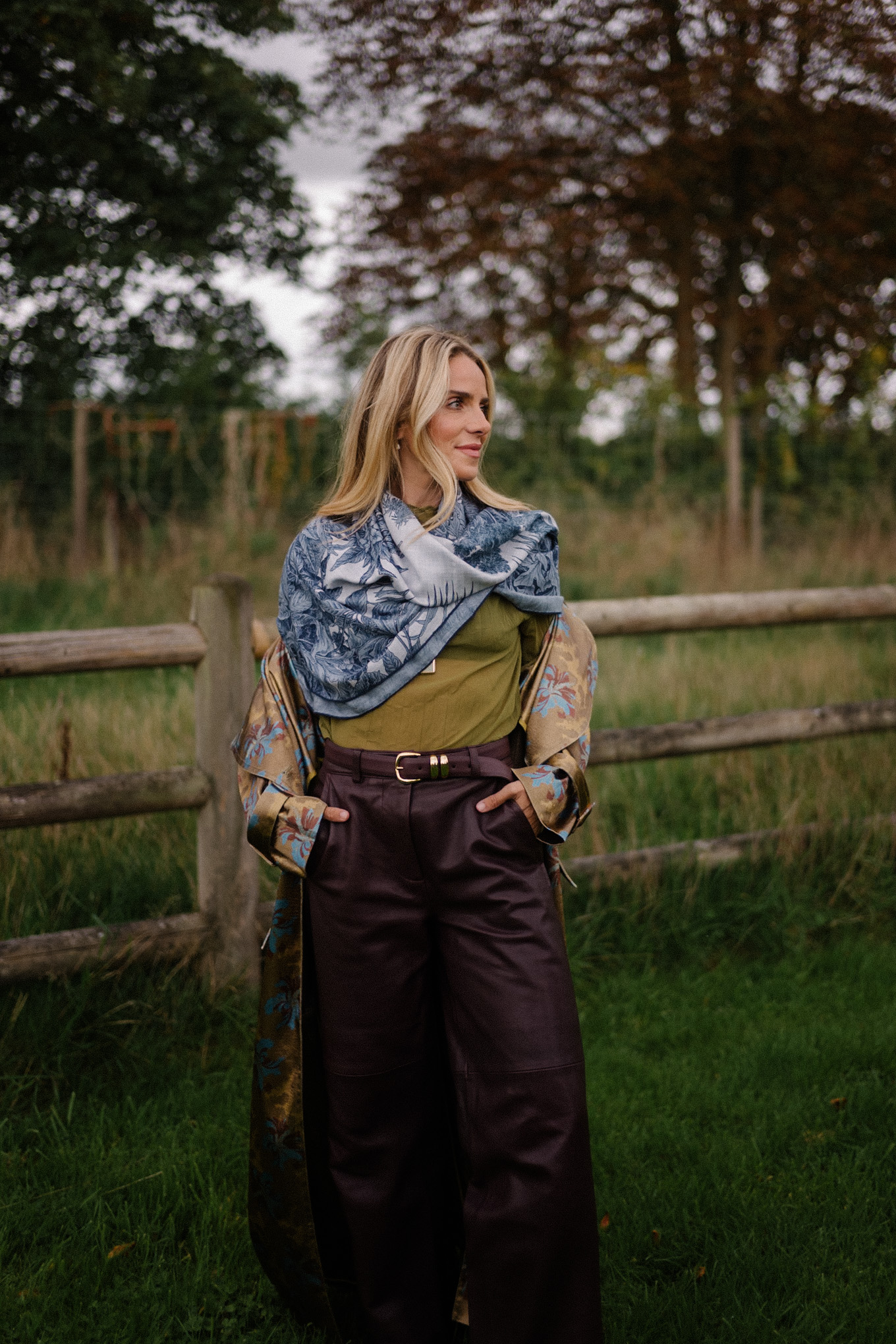 green sheer blouse maroon leather pants blue scarf jacquard trench