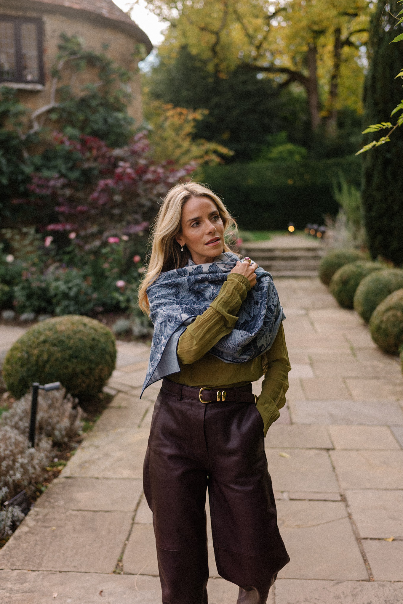 green sheer blouse maroon leather pants blue scarf jacquard trench