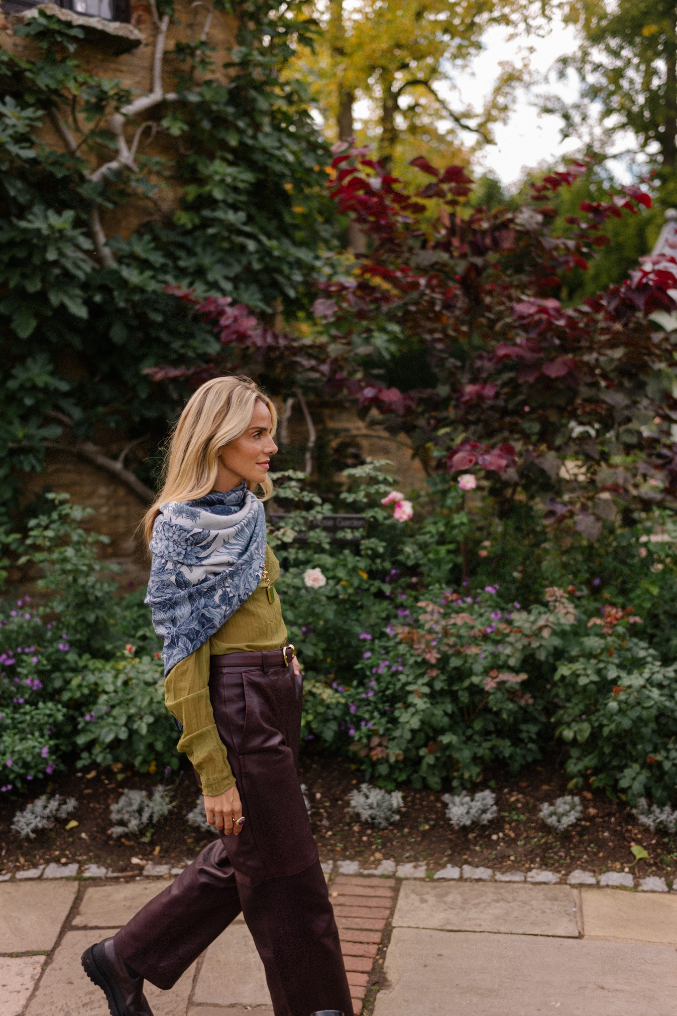 green sheer blouse maroon leather pants blue scarf jacquard trench