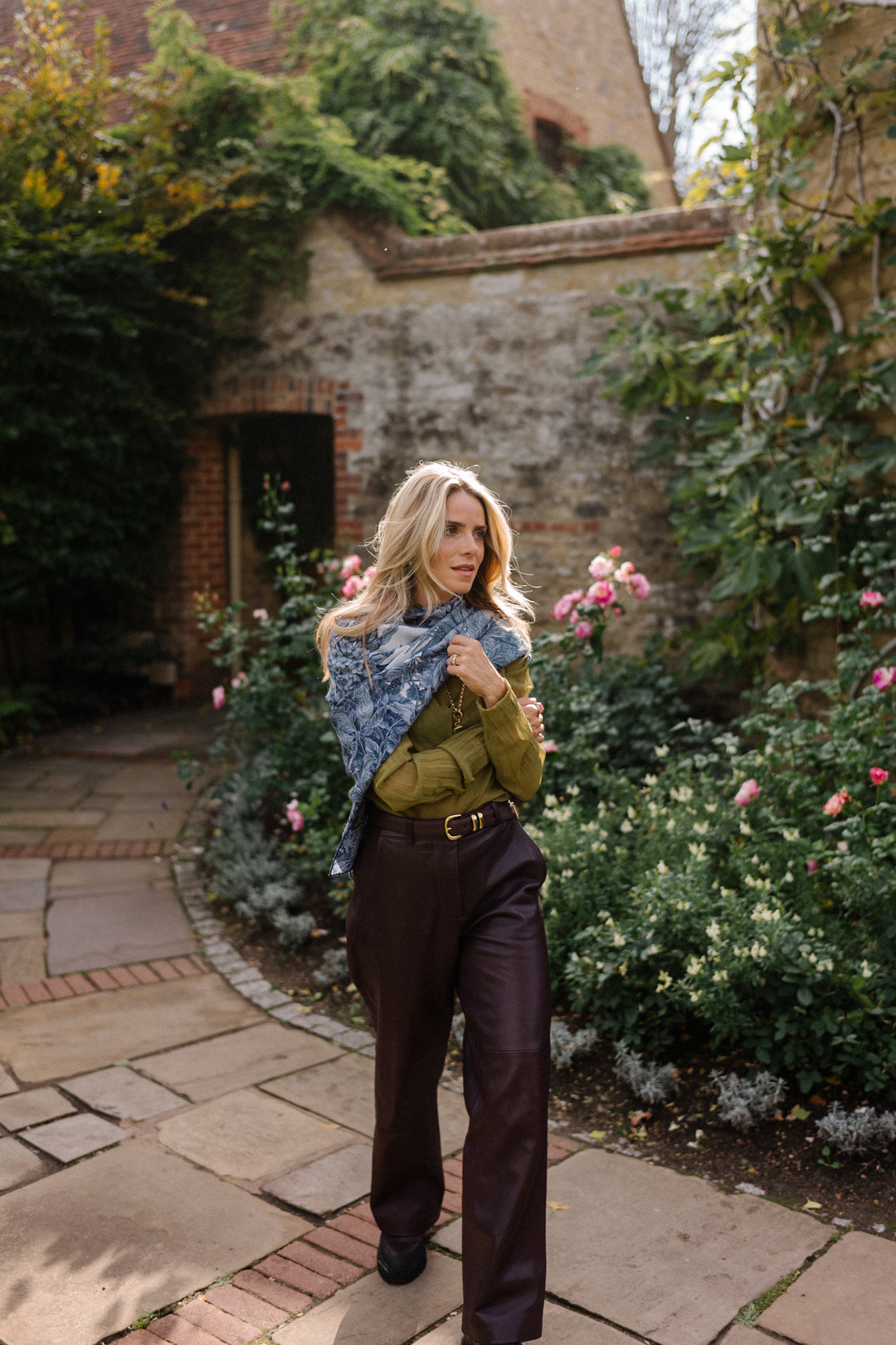 green sheer blouse maroon leather pants blue scarf jacquard trench