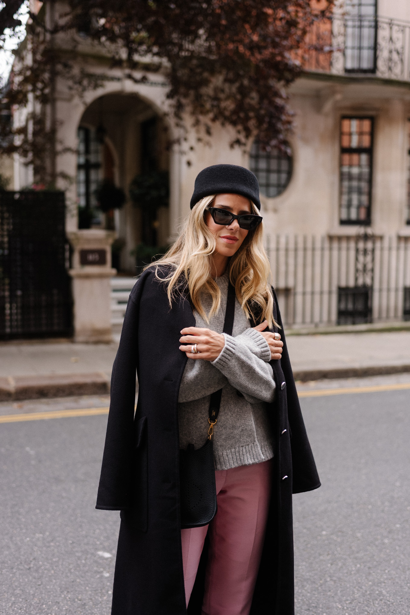 black wool coat grey cardigan pink satin pants black wool pillbox hat