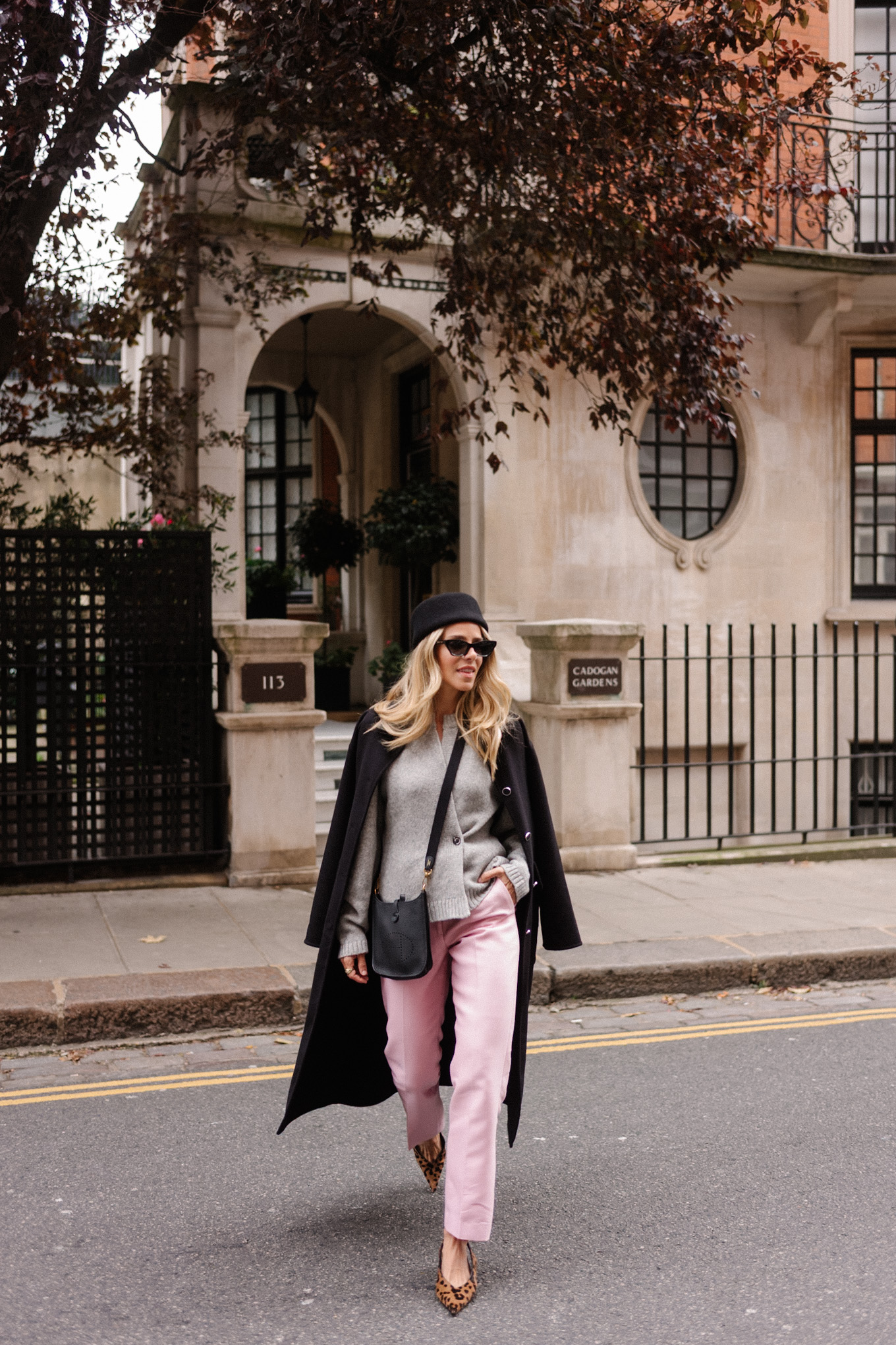 black wool coat grey cardigan pink satin pants black wool pillbox hat