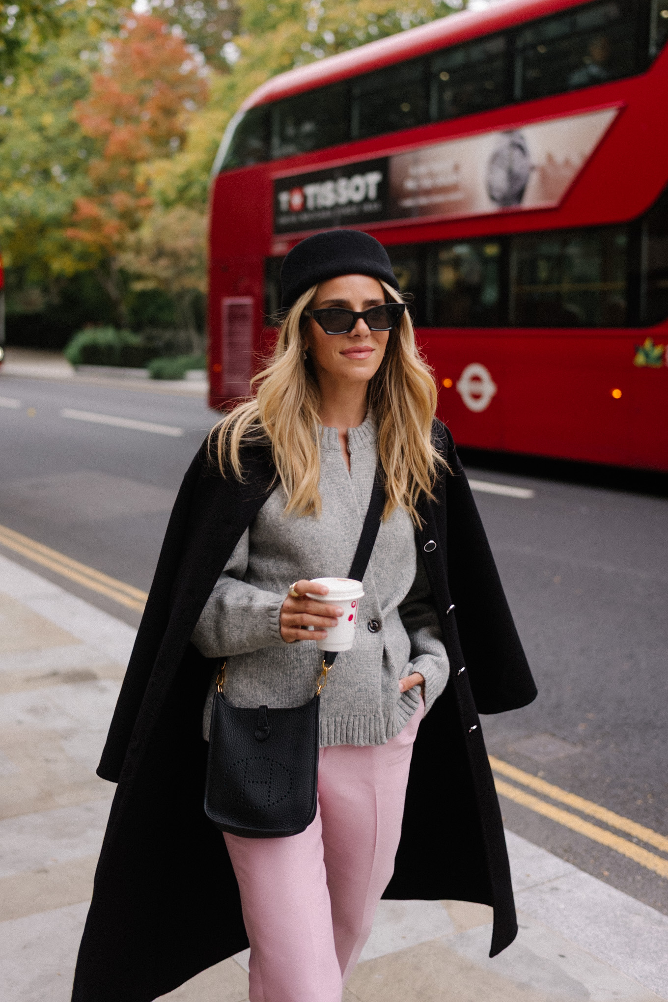 black wool coat grey cardigan pink satin pants black wool pillbox hat