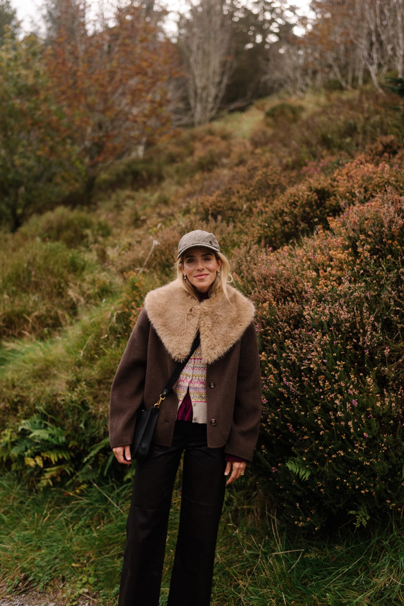 brown wool coat faux fur collar scarf black leather pants cashmere cardigan