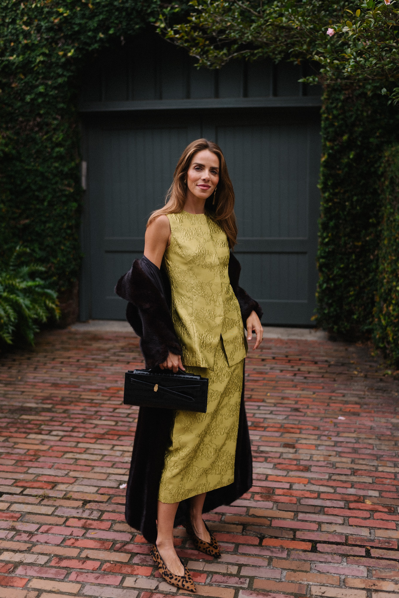 chartreuse top and skirt set black long coat black handbag leopard pumps