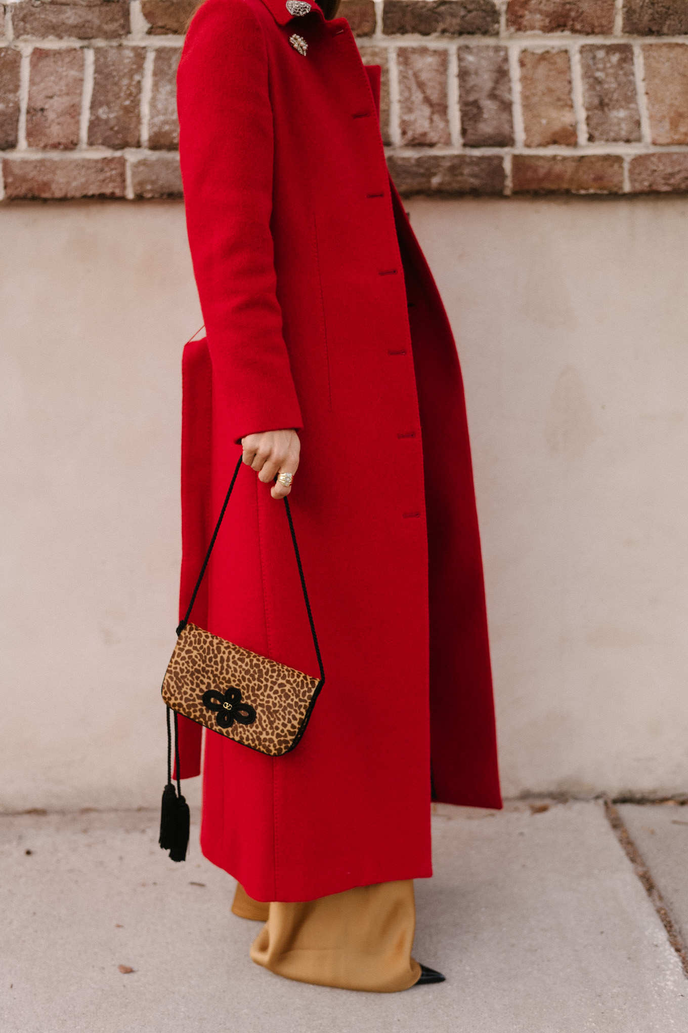 red wool coat red bodysuit gold satin pants leopard handbag
