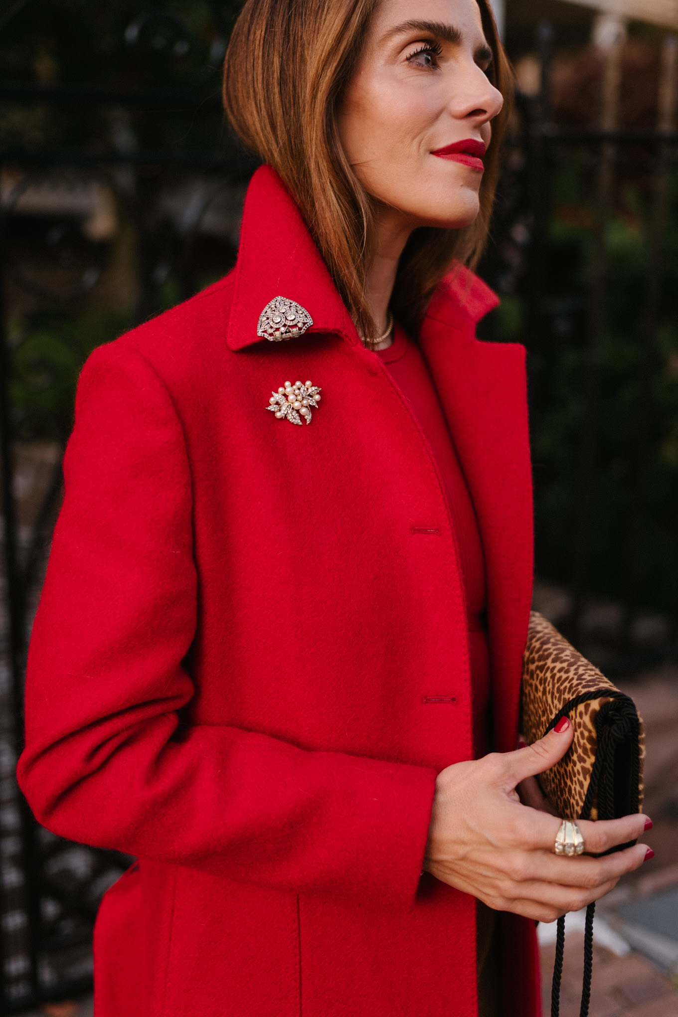 red wool coat red bodysuit gold satin pants leopard handbag