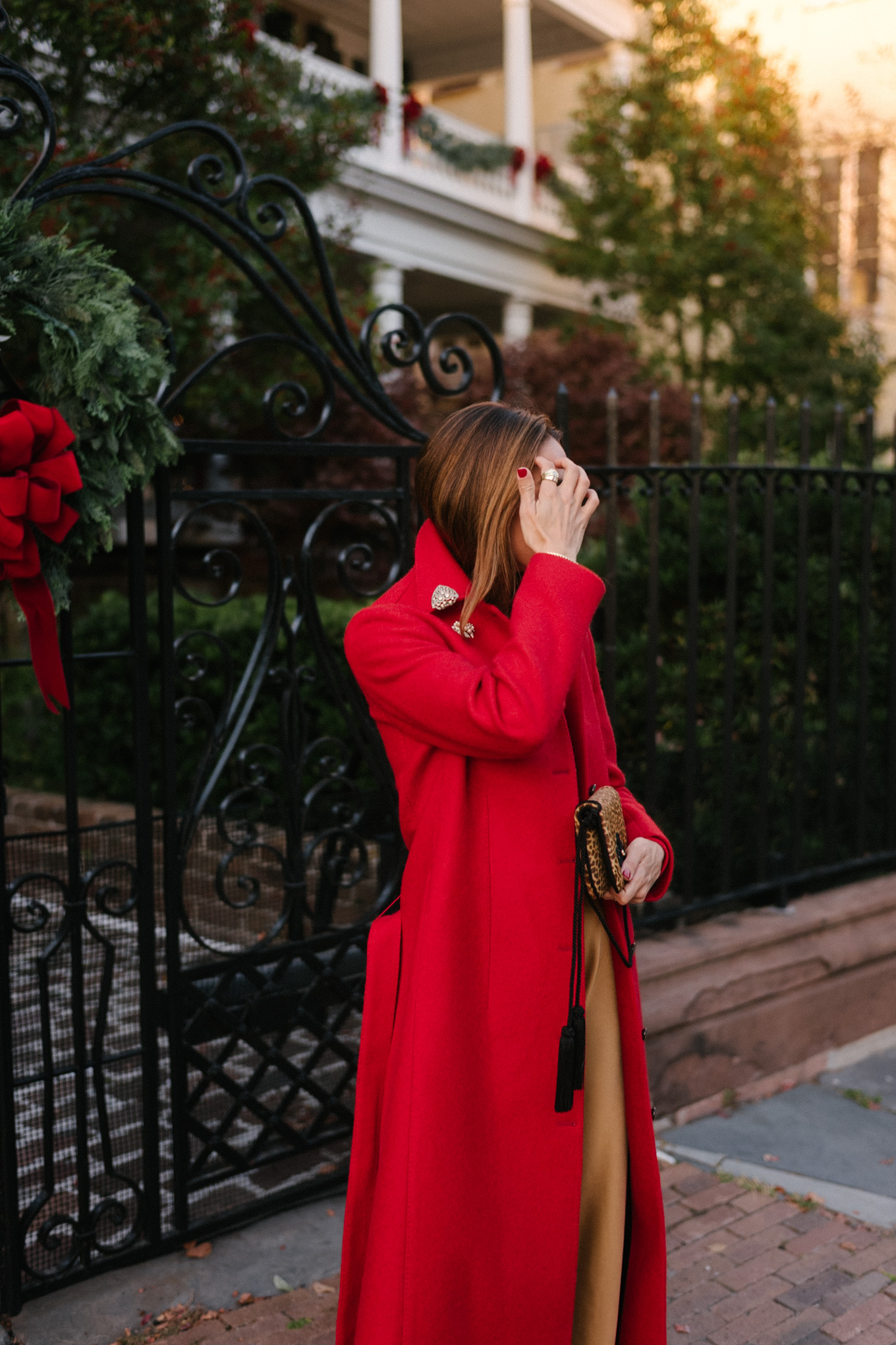 red wool coat red bodysuit gold satin pants leopard handbag