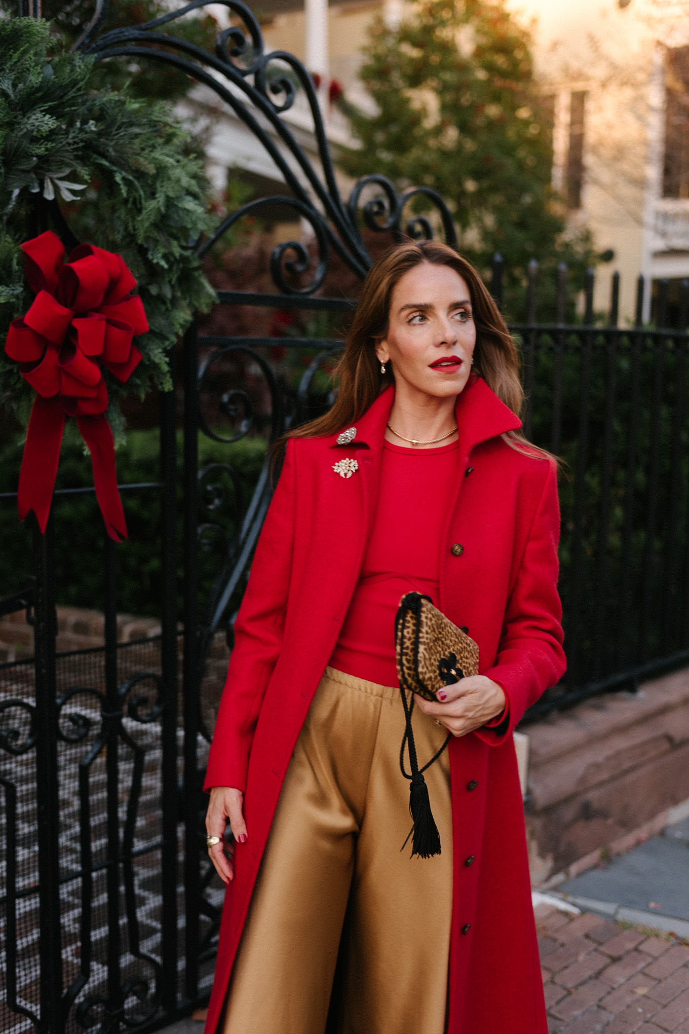 red wool coat red bodysuit gold satin pants leopard handbag