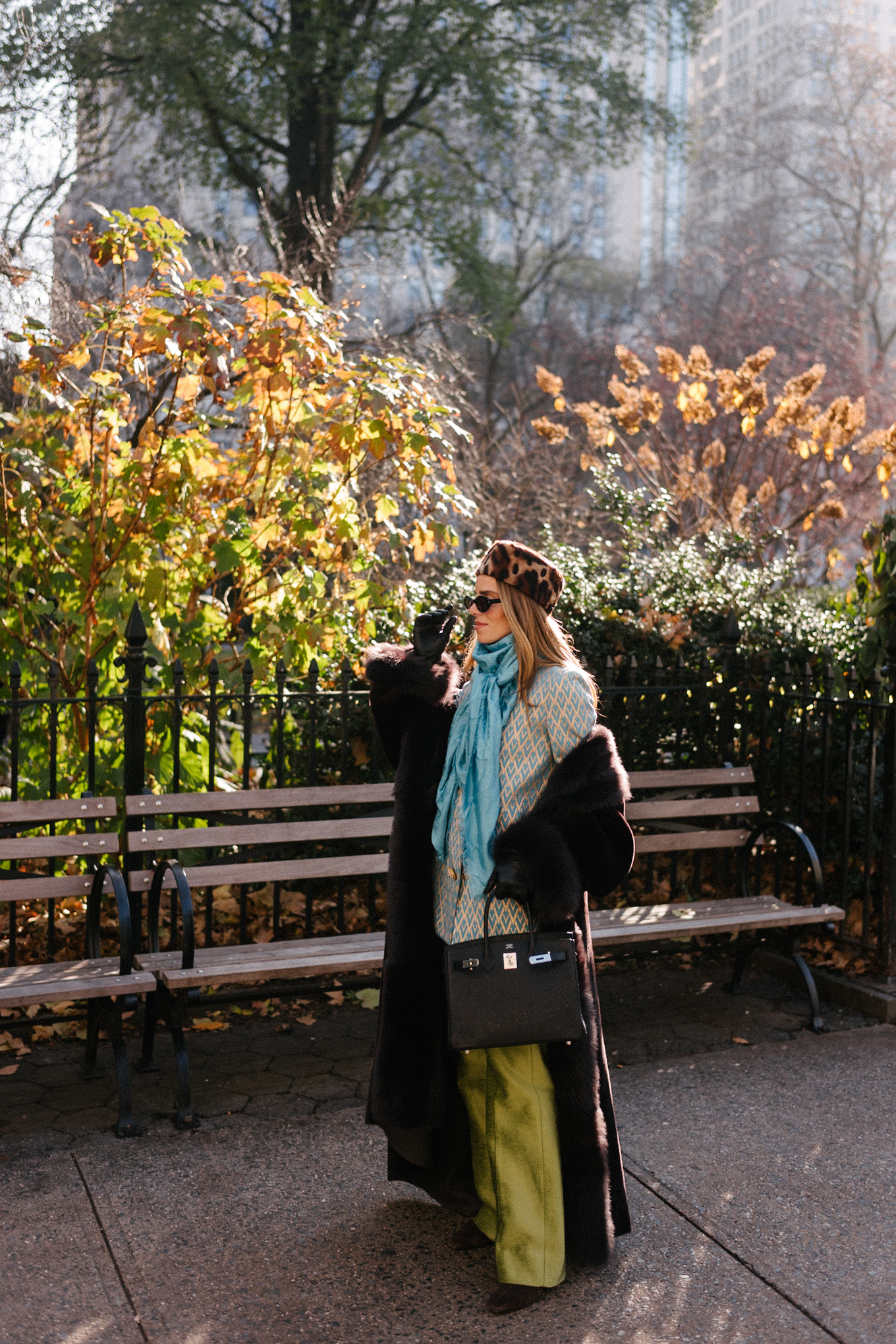 brown shearling coat leopard pill box hat green satin pants turquoise silk scarf