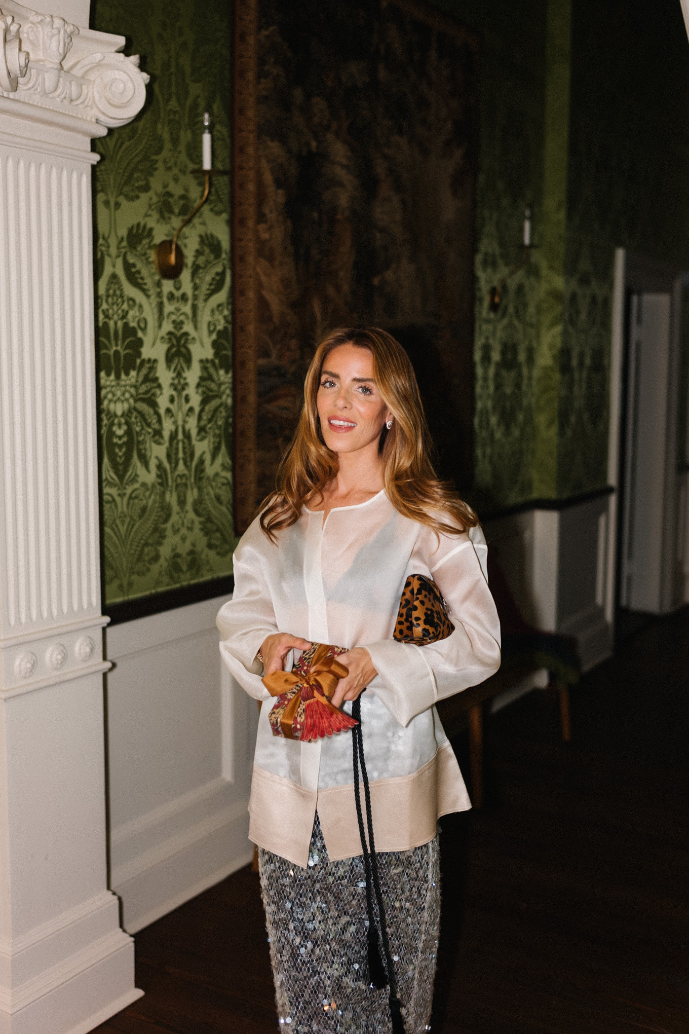 white sheer blouse sparkly silver skirt leopard bag black tassel belt