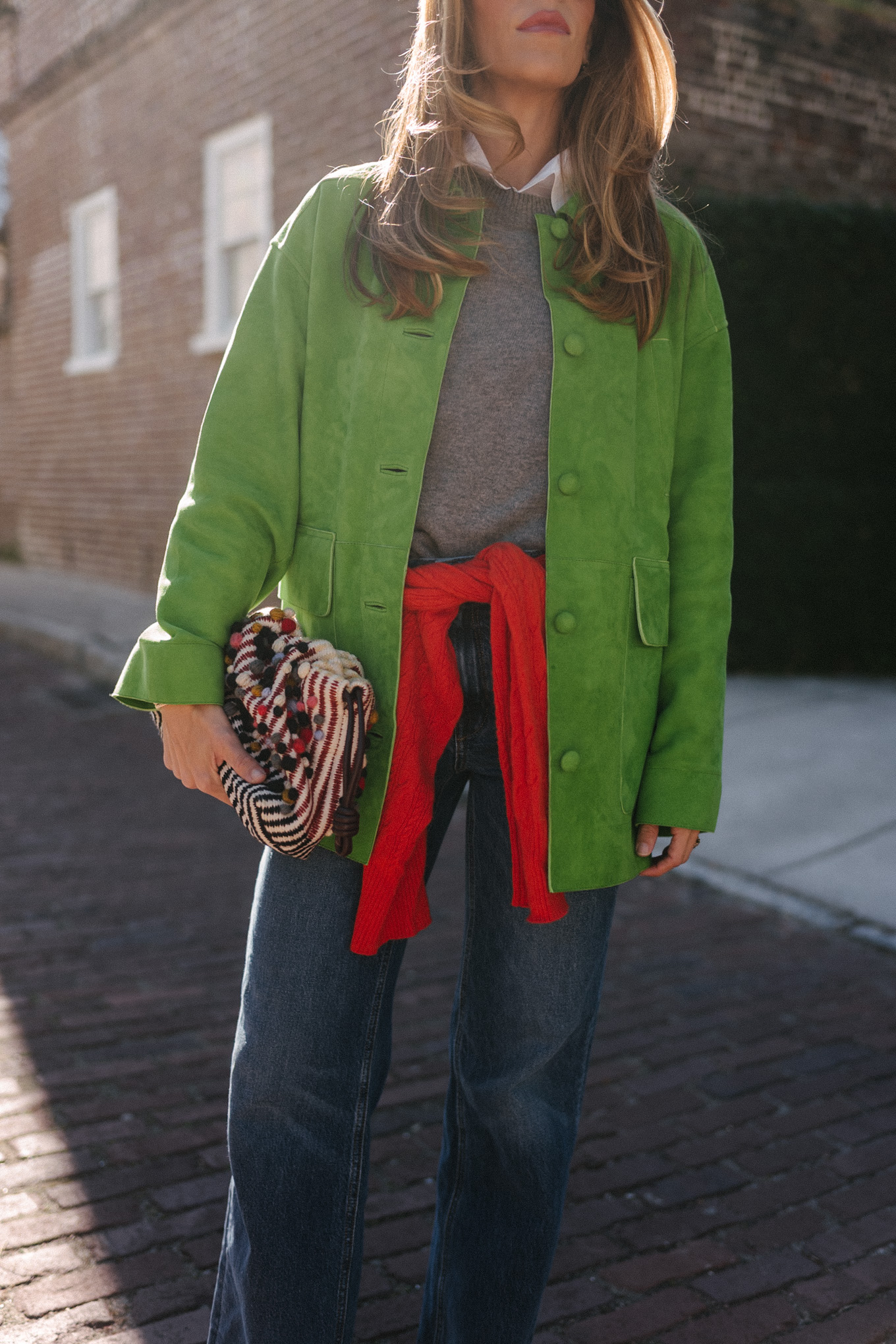 green suede jacket grey wool sweater red cashmere sweater wide leg denim black flats