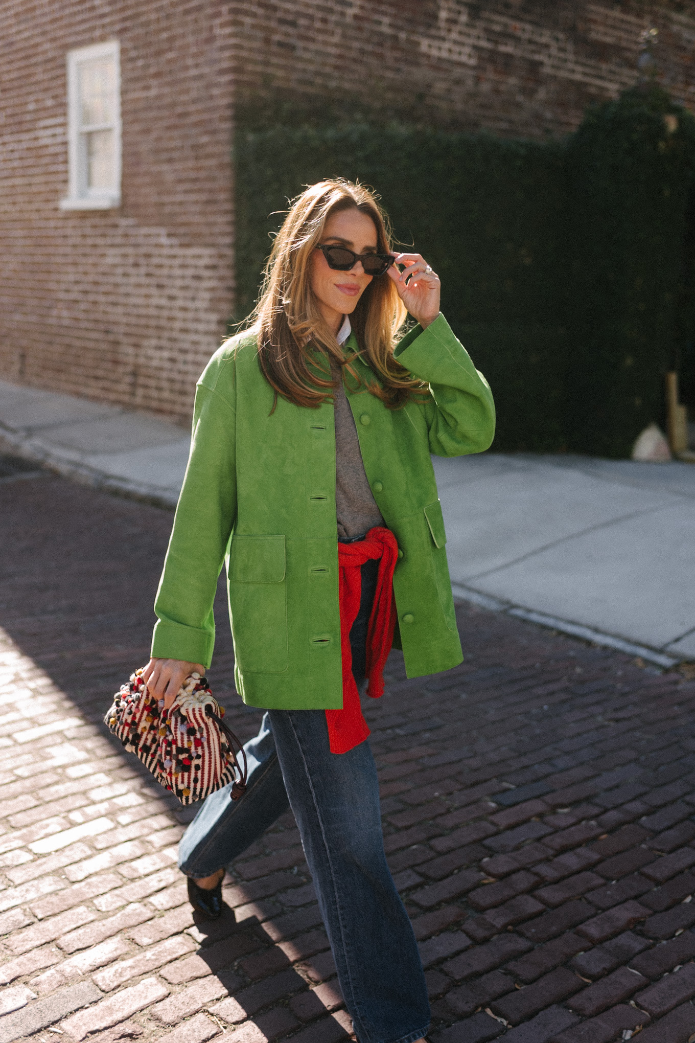 green suede jacket grey wool sweater red cashmere sweater wide leg denim black flats
