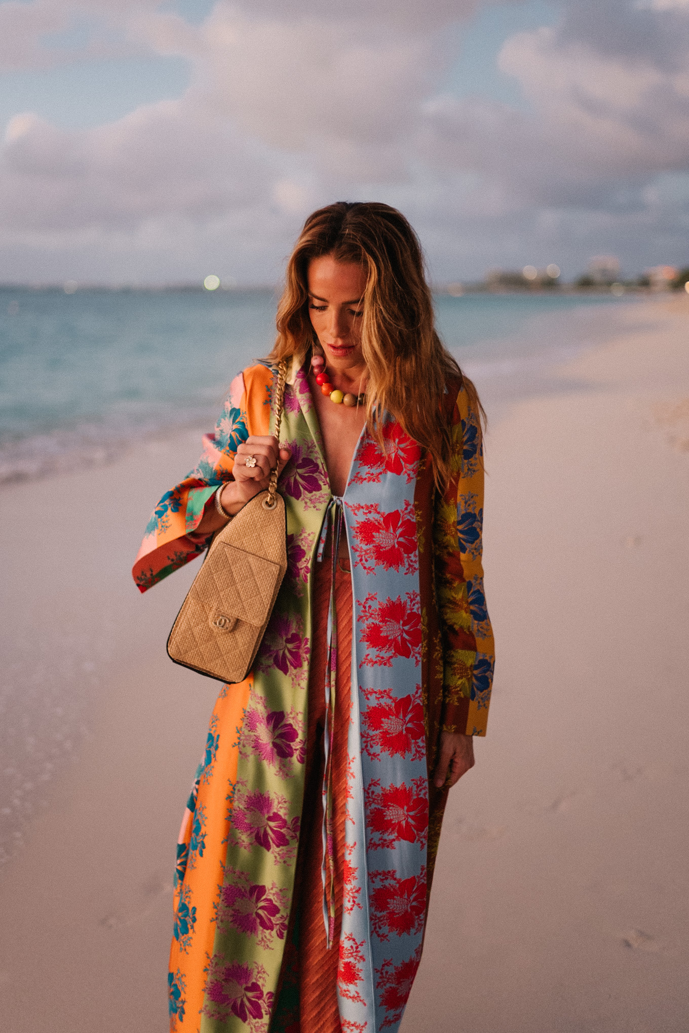 rainbow floral silk jacket silk wide leg pants rainbow beaded necklace rattan bag