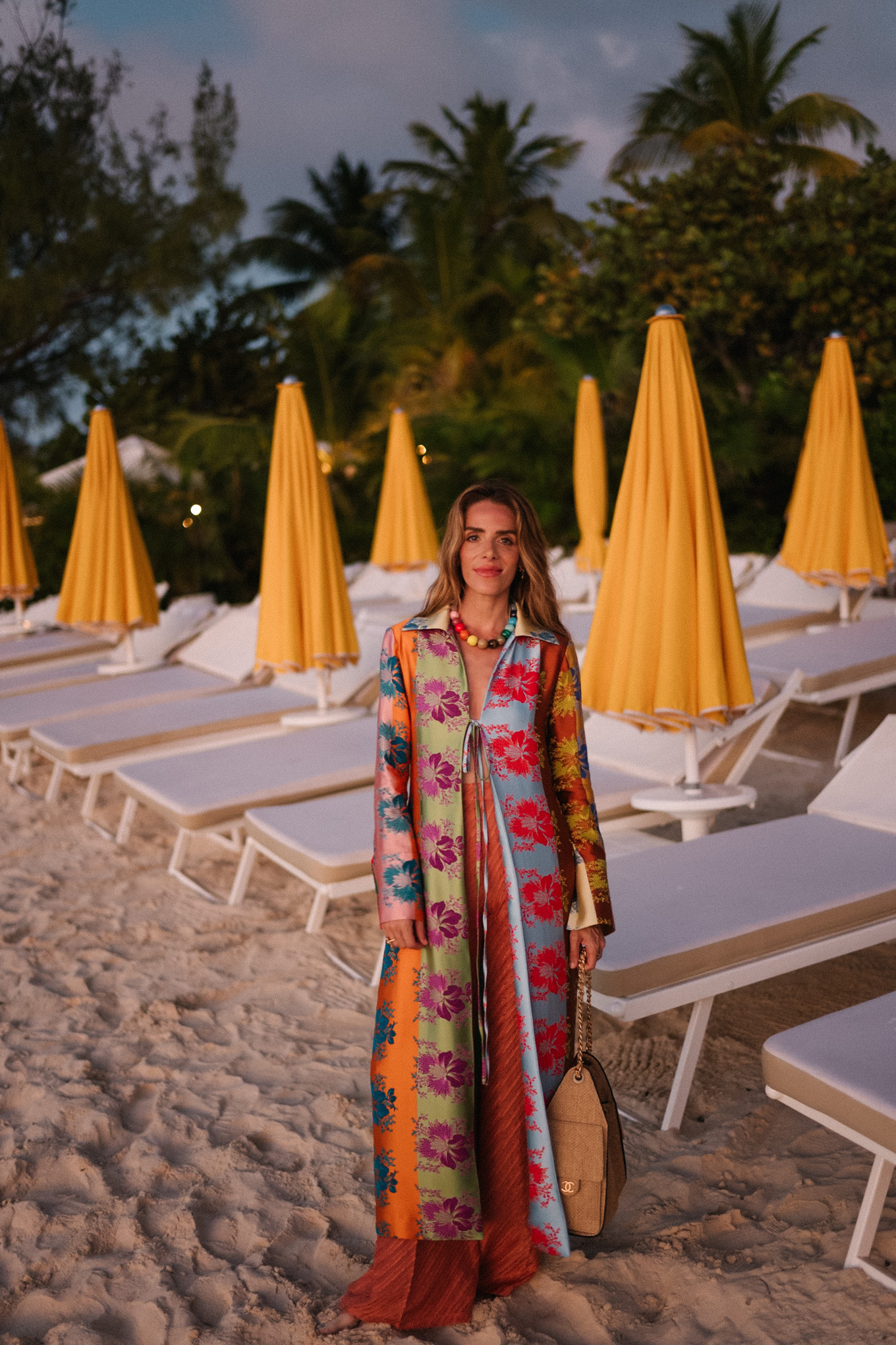 rainbow floral silk jacket silk wide leg pants rainbow beaded necklace rattan bag