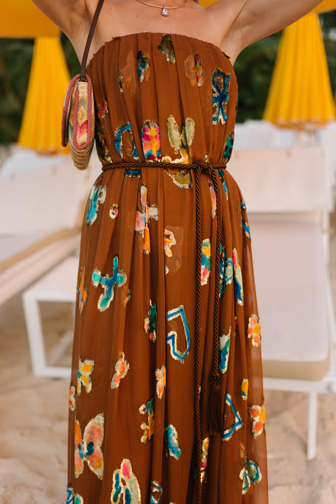 brown strapless maxi dress woven rainbow handbag