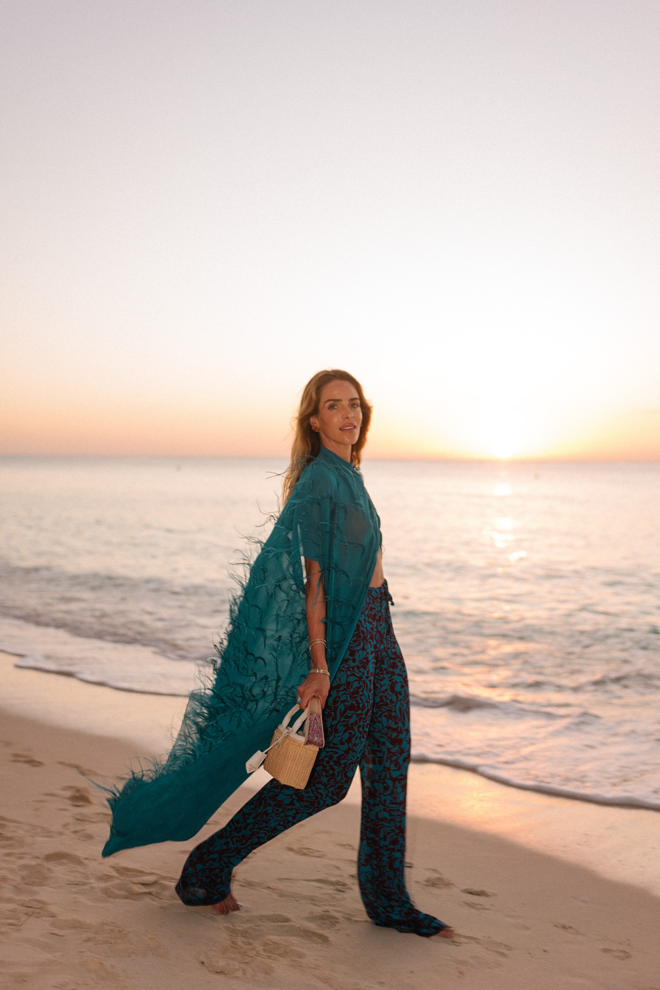 turquoise feathered maxi top turquoise printed wide leg pants wicker handbag