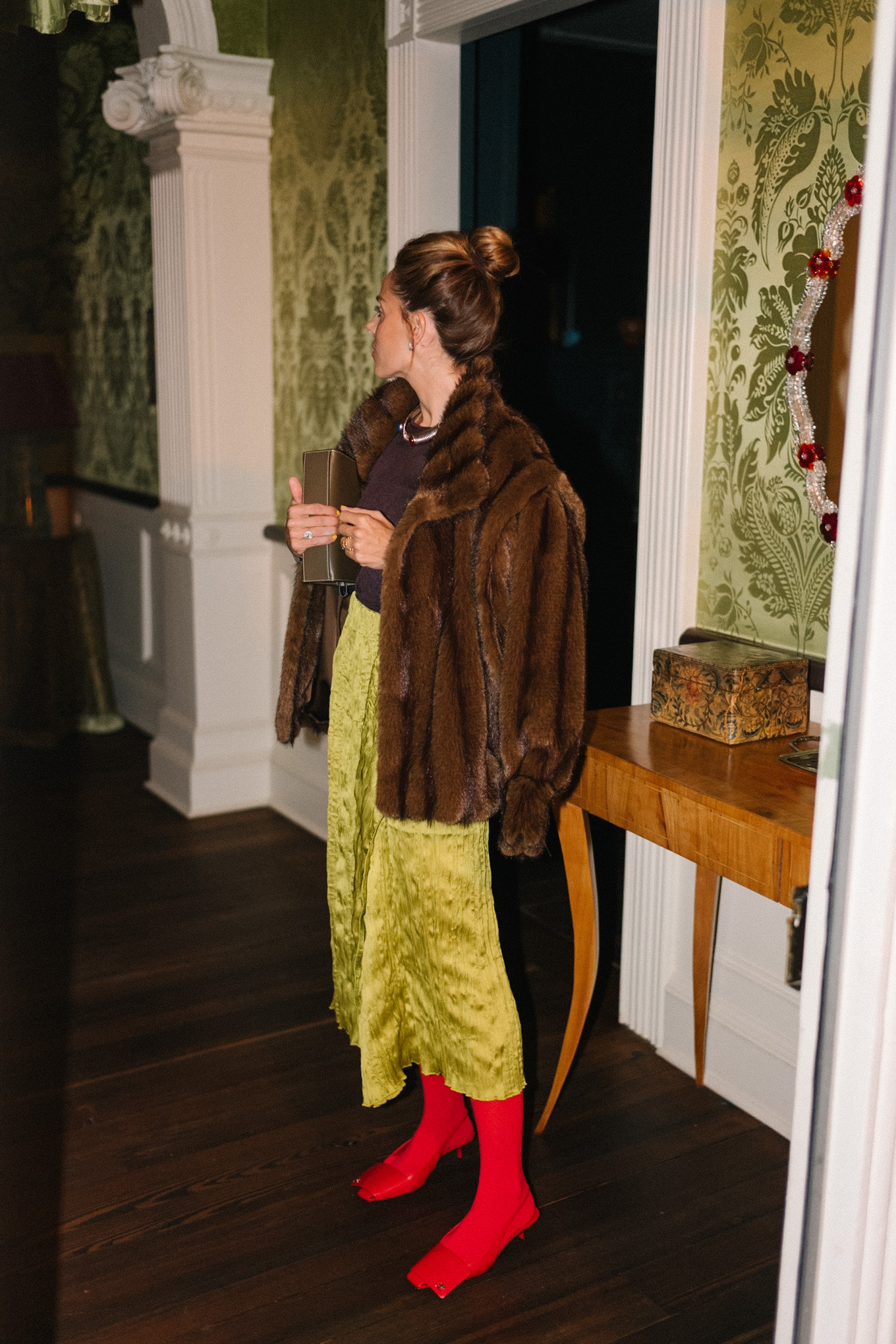 brown faux fur coat brown sheer top green silk skirt red tights red heels