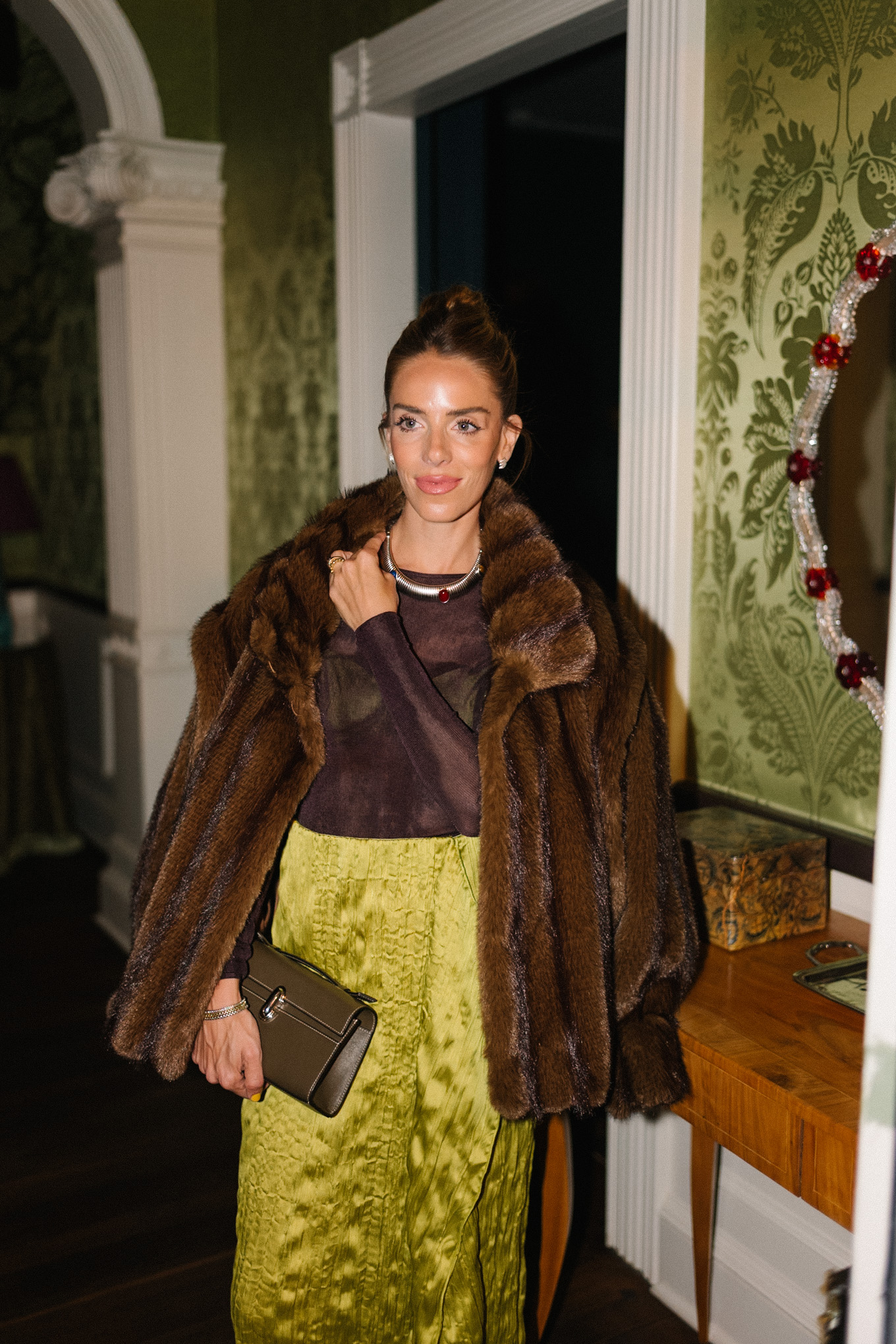 brown faux fur coat brown sheer top green silk skirt red tights red heels