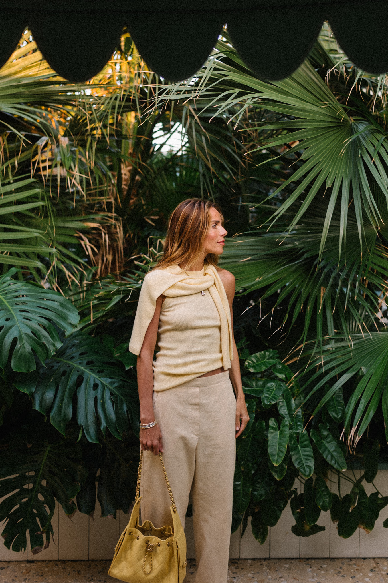 butter yellow sweater tank pants and handbag