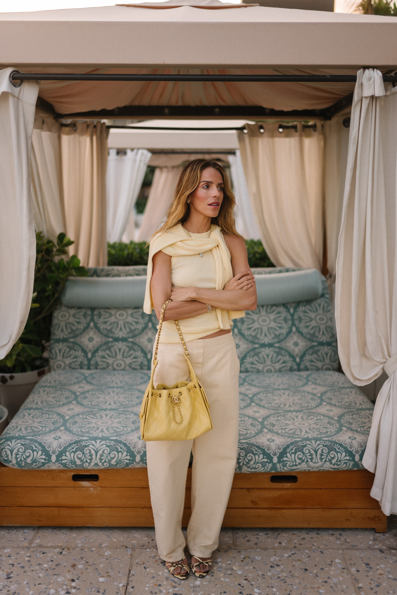 butter yellow sweater tank pants and handbag