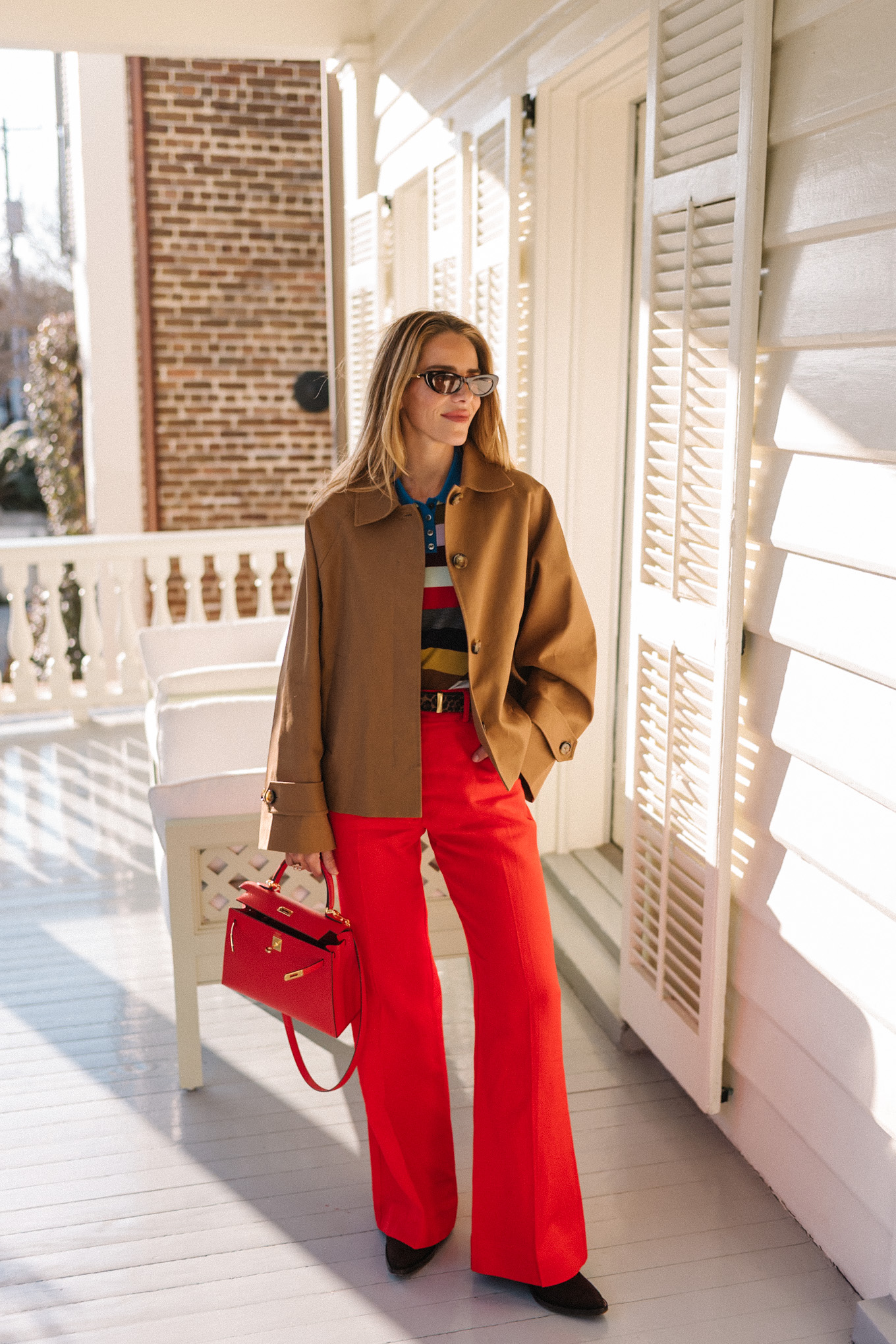brown cropped trench striped collared shirt red pants red leather handbag