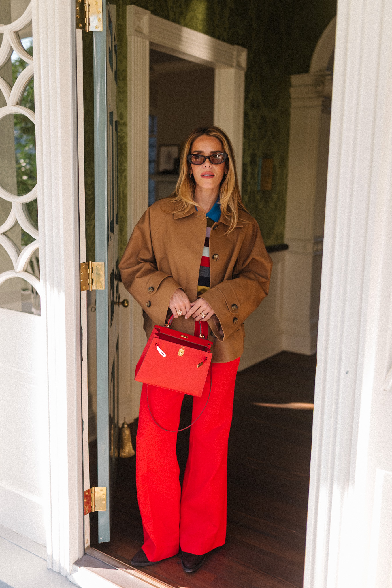 brown cropped trench striped collared shirt red pants red leather handbag