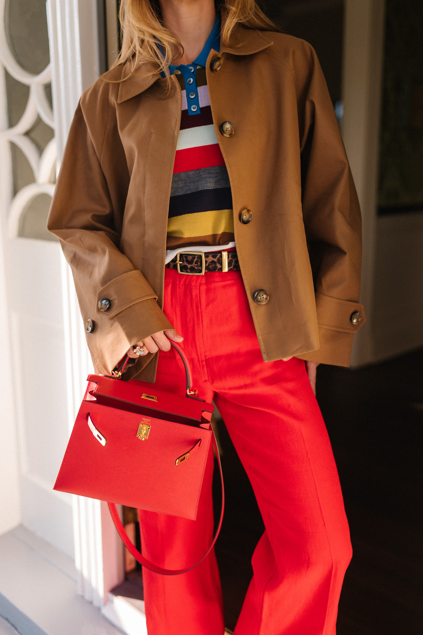 brown cropped trench striped collared shirt red pants red leather handbag