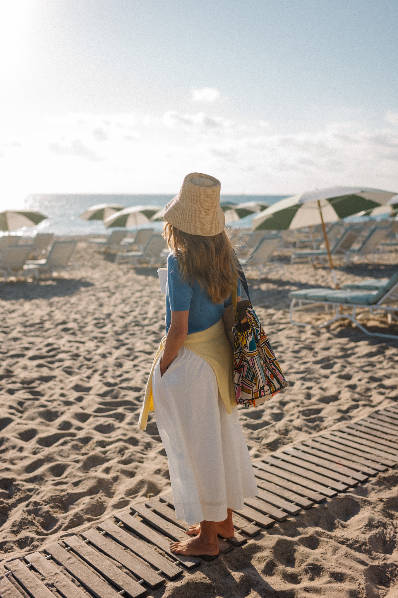 blue collared short sleeved sweater yellow sweater white maxi skirt raffia bucket hat