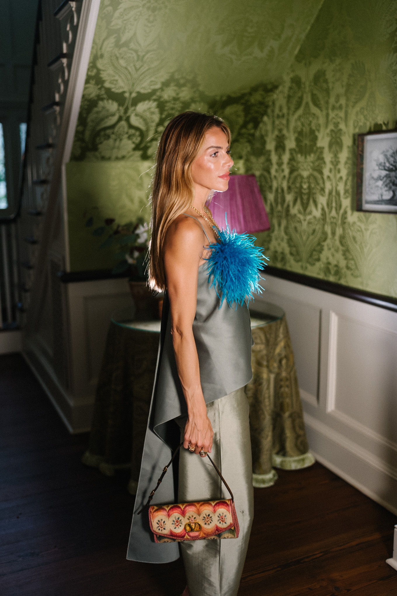 green tank top green taffeta barrel pants blue feather brooch