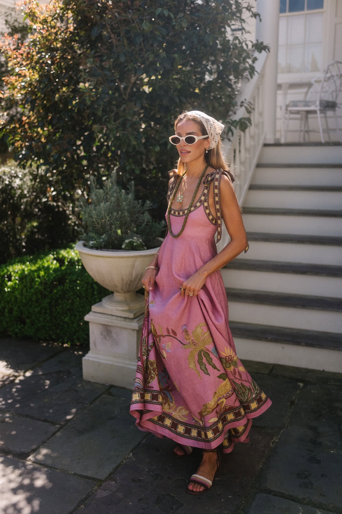 Elegant boho resort wear for summer with pink maxi dress and accessories.
